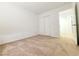 A bedroom with neutral carpeting, white walls and doors, and ample closet space at 7863 Warwickshire Way, Las Vegas, NV 89139