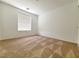 Bedroom featuring neutral colored walls and carpet with a window that allows natural light at 7863 Warwickshire Way, Las Vegas, NV 89139