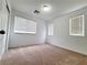 Bright bedroom with neutral colored carpet, white walls, and windows with blinds at 7863 Warwickshire Way, Las Vegas, NV 89139