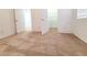 Bright bedroom with neutral carpet and a view of a walk-in closet through the doorway at 7863 Warwickshire Way, Las Vegas, NV 89139