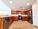 Updated kitchen featuring stainless steel appliances and wood cabinets at 7863 Warwickshire Way, Las Vegas, NV 89139