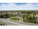A scenic view of the neighborhood entrance with palm trees and manicured landscaping welcoming residents and guests at 7988 Harbour Towne Ave, Las Vegas, NV 89113