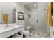 Bathroom featuring walk-in shower, with a white vanity, gold fixtures and neutral color palette at 7988 Harbour Towne Ave, Las Vegas, NV 89113