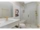 Bathroom with a glass-enclosed shower, a white vanity, and gold fixtures at 7988 Harbour Towne Ave, Las Vegas, NV 89113