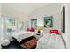 Bright bedroom with two twin beds, dark floors, and fun vintage art pieces at 7988 Harbour Towne Ave, Las Vegas, NV 89113