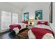 Inviting bedroom with two twin beds, vintage art prints, and a large window offering plenty of natural light at 7988 Harbour Towne Ave, Las Vegas, NV 89113