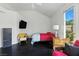 Bedroom featuring a TV, ample natural light, and seating area at 7988 Harbour Towne Ave, Las Vegas, NV 89113