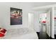 Cozy bedroom with dark wood floors that open to a full bath and the living area at 7988 Harbour Towne Ave, Las Vegas, NV 89113