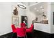 Dining area with a glass-top table, red chairs, and modern lighting at 7988 Harbour Towne Ave, Las Vegas, NV 89113
