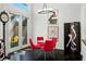 Bright dining area featuring a glass table with red chairs and artful decor at 7988 Harbour Towne Ave, Las Vegas, NV 89113