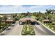 A grand entrance to the gated community is marked by tiled roofs, stone columns, and manicured landscaping at 7988 Harbour Towne Ave, Las Vegas, NV 89113