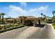 A stately gated entrance provides security and privacy with decorative landscaping enhancing curb appeal at 7988 Harbour Towne Ave, Las Vegas, NV 89113