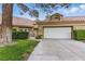 Charming single-story home featuring a two-car garage, tile roof, and mature landscaping at 7988 Harbour Towne Ave, Las Vegas, NV 89113