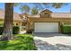 Charming home with a red tile roof, manicured lawn and lush landscaping at 7988 Harbour Towne Ave, Las Vegas, NV 89113