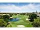 Aerial view of lush golf course with pond, sand traps, and beautiful homes at 7988 Harbour Towne Ave, Las Vegas, NV 89113