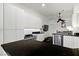 Clean kitchen with white cabinetry, stainless steel appliances, and a black countertop at 7988 Harbour Towne Ave, Las Vegas, NV 89113
