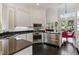 Modern kitchen featuring white cabinets, stainless steel appliances, and dark countertops at 7988 Harbour Towne Ave, Las Vegas, NV 89113