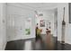 Bright entryway featuring dark hardwood floors, white walls, and a giraffe statue at 7988 Harbour Towne Ave, Las Vegas, NV 89113