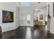 Bright entryway featuring dark hardwood floors, white walls, and a giraffe statue at 7988 Harbour Towne Ave, Las Vegas, NV 89113