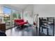 Living room with a fireplace, a red futon, and lots of natural light from the backyard doors at 7988 Harbour Towne Ave, Las Vegas, NV 89113
