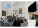 Bright living room with high ceilings, modern furnishings, and a cozy fireplace at 7988 Harbour Towne Ave, Las Vegas, NV 89113