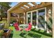 Inviting covered patio with outdoor seating area and sliding glass doors into the home at 7988 Harbour Towne Ave, Las Vegas, NV 89113