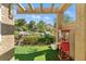 Cozy covered patio with a vintage popcorn machine and views of the lush landscaping at 7988 Harbour Towne Ave, Las Vegas, NV 89113