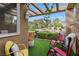Secluded patio with seating, trellis cover, and picturesque views of the landscaped backyard at 7988 Harbour Towne Ave, Las Vegas, NV 89113