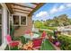 Charming patio with covered trellis, lush landscaping, and outdoor seating, perfect for relaxation at 7988 Harbour Towne Ave, Las Vegas, NV 89113