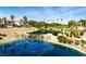 Scenic shot of water feature, palm trees, golf course, and white home in the background at 7988 Harbour Towne Ave, Las Vegas, NV 89113
