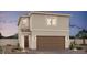 Two-story home featuring a brown garage door, desert landscaping, and a covered porch entry at 8119 Beebrush Ct, Las Vegas, NV 89113