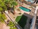 Beautiful backyard aerial view with a rock pool, artificial grass, mature palm trees, and private setting at 8320 Deer Springs Way, Las Vegas, NV 89149