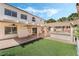 Back yard featuring a covered patio, well-kept lawn, and lush greenery for a serene outdoor experience at 8320 Deer Springs Way, Las Vegas, NV 89149