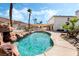 Stunning backyard pool with rock features, mature palms, and outdoor kitchen, perfect for outdoor relaxation at 8320 Deer Springs Way, Las Vegas, NV 89149