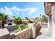 Charming balcony view overlooking palm trees, a nearby street, and other homes in the neighborhood at 8320 Deer Springs Way, Las Vegas, NV 89149