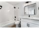 Updated bathroom with a tub, white cabinets, stylish lighting, and a modern faucet at 8320 Deer Springs Way, Las Vegas, NV 89149