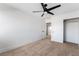 Bright bedroom features neutral carpet, a modern ceiling fan, and a closet at 8320 Deer Springs Way, Las Vegas, NV 89149