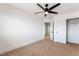 Bright bedroom features neutral carpet, a modern ceiling fan, and a closet at 8320 Deer Springs Way, Las Vegas, NV 89149