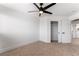 Cozy bedroom with neutral carpet, ceiling fan, and closet with sliding doors, offering a comfortable living space at 8320 Deer Springs Way, Las Vegas, NV 89149