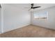 Inviting bedroom with natural light, ceiling fan, neutral carpet, and a pleasant view from the window at 8320 Deer Springs Way, Las Vegas, NV 89149