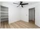 Clean bedroom with wood-look floors, a ceiling fan, and two closets for plenty of storage at 8320 Deer Springs Way, Las Vegas, NV 89149