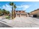 Inviting two-story home with a spacious three-car garage and mature palm trees at 8320 Deer Springs Way, Las Vegas, NV 89149