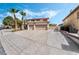 Inviting two-story home with a spacious three-car garage and mature palm trees at 8320 Deer Springs Way, Las Vegas, NV 89149