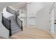 Bright foyer featuring a staircase with black railing and beautiful wood floors at 8320 Deer Springs Way, Las Vegas, NV 89149