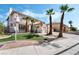 Inviting two-story home with desert landscaping and mature palm trees at 8320 Deer Springs Way, Las Vegas, NV 89149