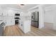 Open kitchen featuring white cabinetry, stainless steel appliances, and a center island for ample workspace at 8320 Deer Springs Way, Las Vegas, NV 89149