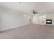 Spacious living room features a cozy fireplace, ceiling fan, neutral carpet, and ample natural light at 8320 Deer Springs Way, Las Vegas, NV 89149