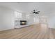 Spacious living room with wood floors, a ceiling fan, and a modern fireplace at 8320 Deer Springs Way, Las Vegas, NV 89149