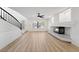 Bright living room featuring wood floors, a fireplace, and staircase at 8320 Deer Springs Way, Las Vegas, NV 89149