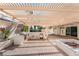 Inviting outdoor kitchen with pergola, BBQ grill, mini fridge, and cozy fire pit, perfect for entertaining at 8320 Deer Springs Way, Las Vegas, NV 89149